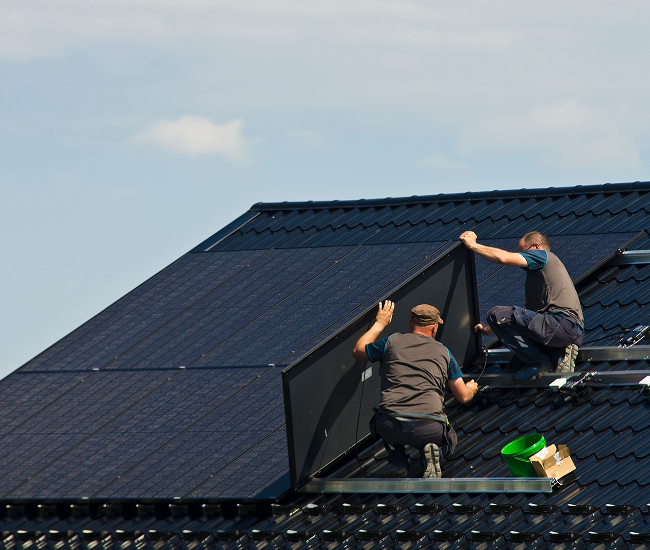 Solar technicians installing solar panel array